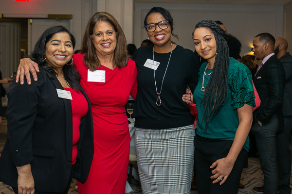 Four women pose for a photo at the 20th anniversary event