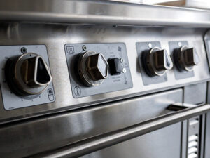 Devin Flores/Cornell University A close-up of diamond and triangle shaped knobs on the front of an induction stove.