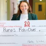 Avery Sheppard holds her first place $25,000 prize.